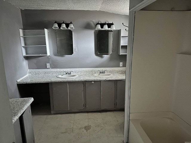 bathroom featuring tile flooring, a textured ceiling, and double vanity