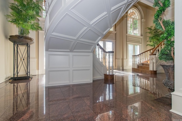 interior space featuring dark tile floors and a towering ceiling