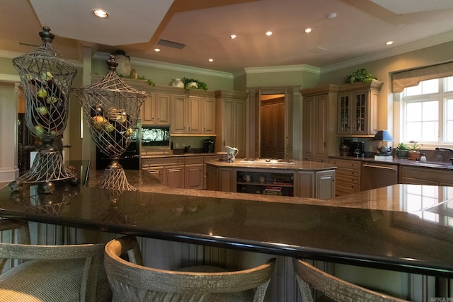 kitchen featuring a kitchen breakfast bar, sink, stainless steel appliances, beverage cooler, and a kitchen island