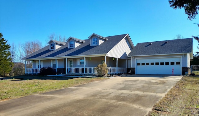 cape cod house featuring a porch, a front yard, and a garage