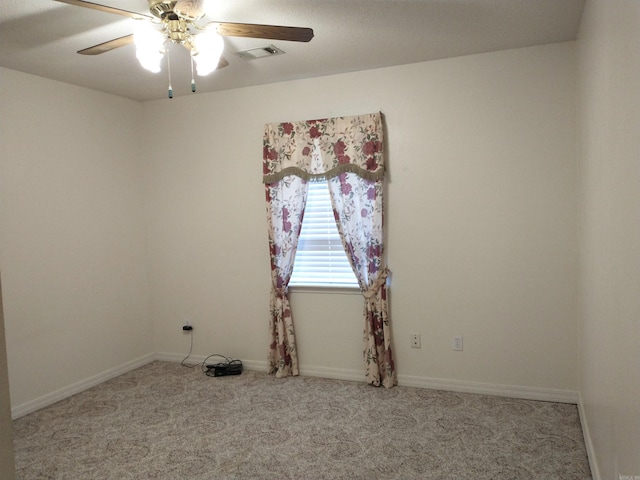 carpeted spare room with ceiling fan