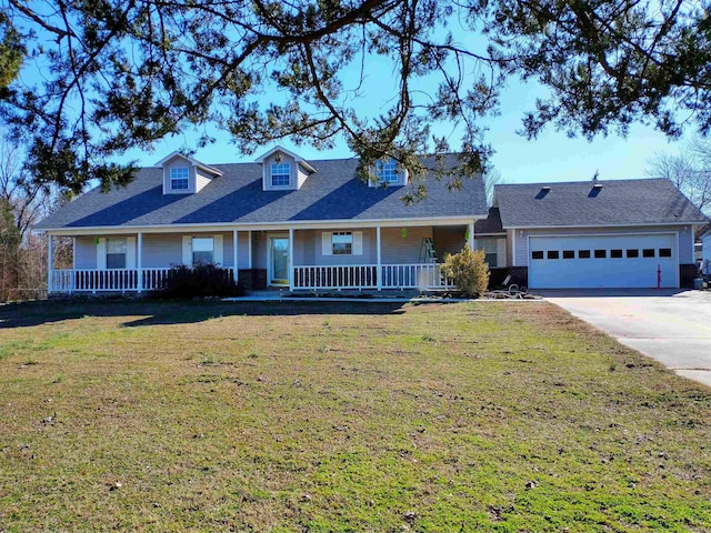 view of front of property with a front lawn, covered porch, and a garage