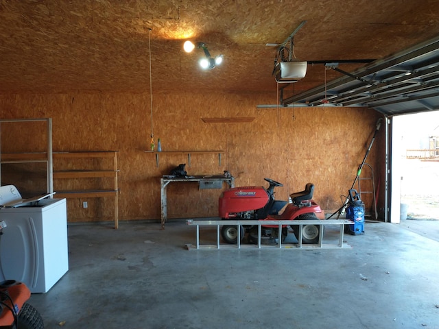 garage with washer / clothes dryer and a garage door opener