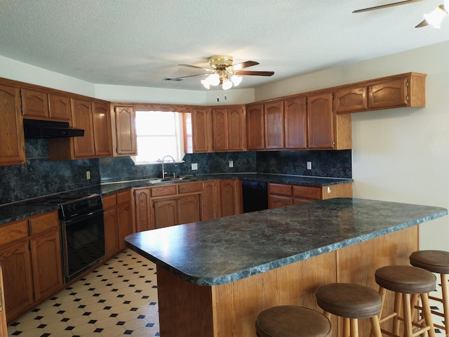 kitchen with ceiling fan, range, sink, and tasteful backsplash