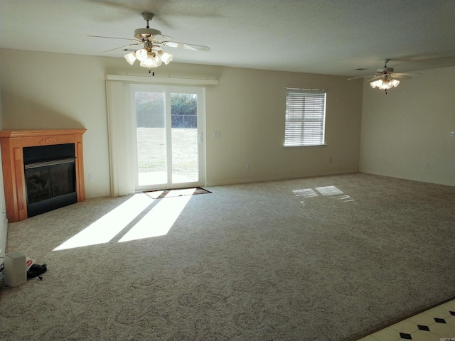 unfurnished living room with ceiling fan and light colored carpet