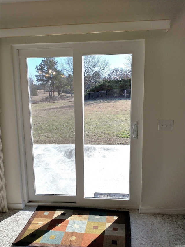 entryway featuring carpet flooring and a healthy amount of sunlight