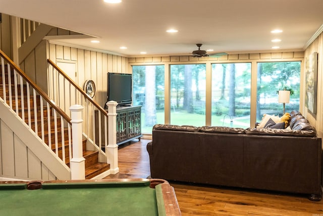 living room featuring ceiling fan, wood-type flooring, crown molding, and billiards