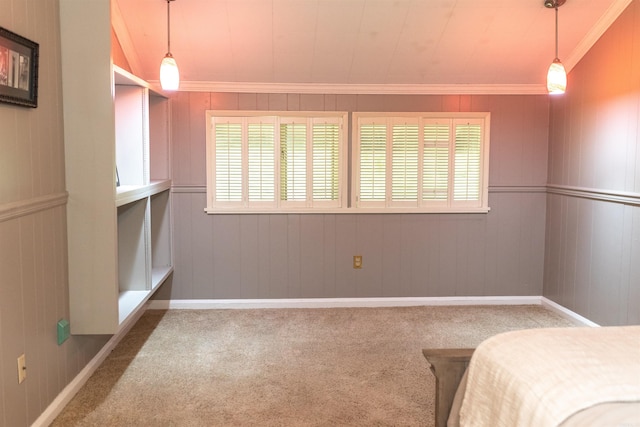 unfurnished bedroom featuring lofted ceiling, wood walls, carpet floors, and multiple windows