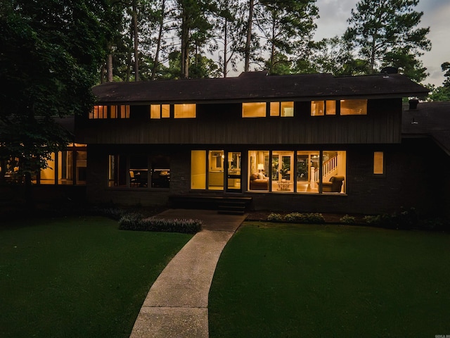 view of front of house with a lawn and a patio area