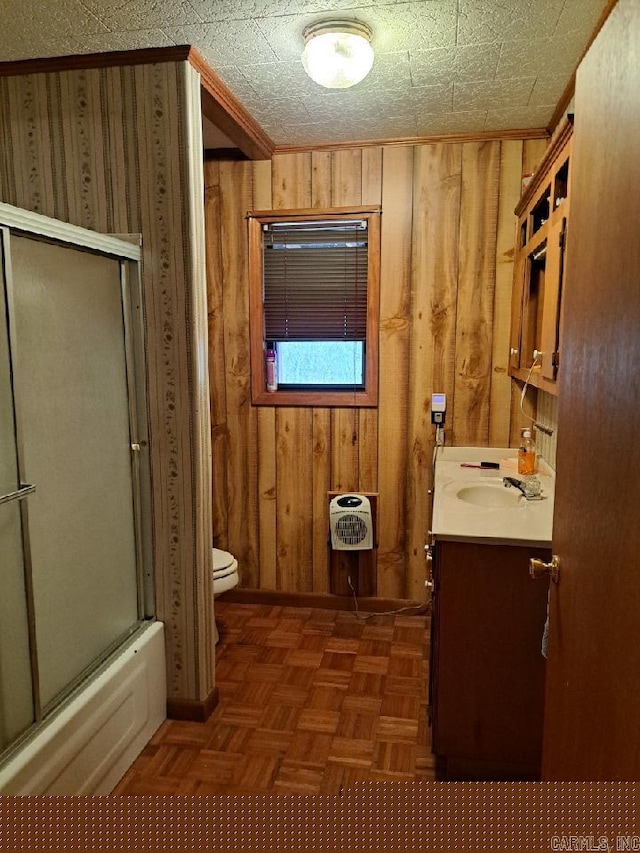 full bathroom featuring heating unit, wooden walls, toilet, and vanity