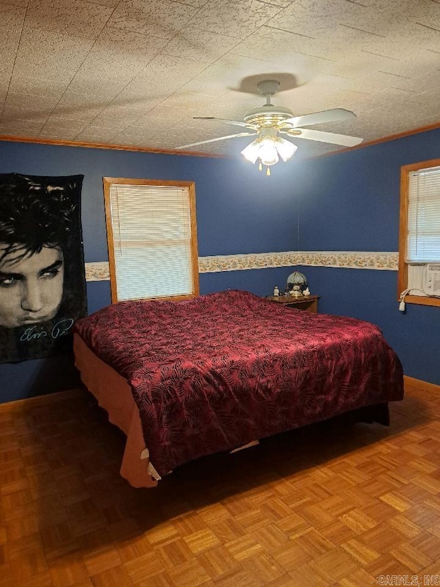 bedroom with a textured ceiling, cooling unit, and ceiling fan