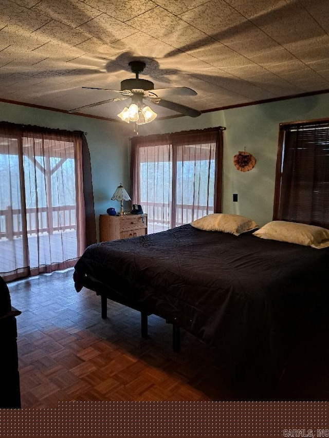 bedroom featuring access to exterior, crown molding, and ceiling fan