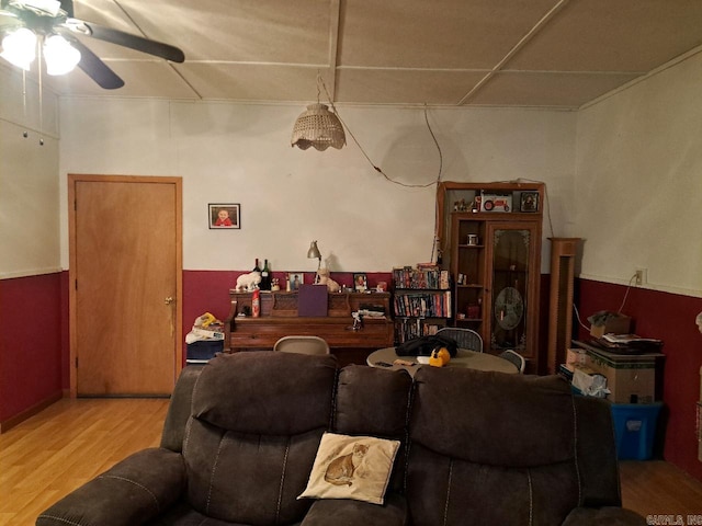 living area with ceiling fan and wood finished floors