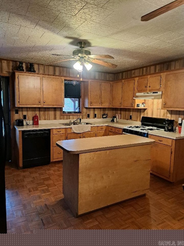 kitchen featuring range with gas stovetop, a ceiling fan, light countertops, black dishwasher, and under cabinet range hood