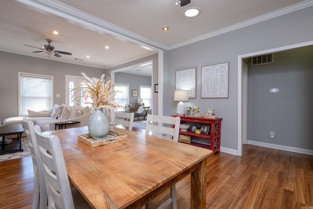 dining area with ceiling fan, dark wood-type flooring, and ornamental molding