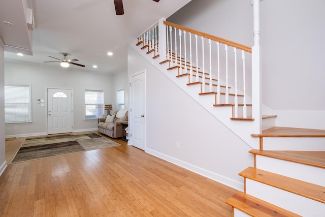 entryway with light hardwood / wood-style flooring, ornamental molding, and ceiling fan