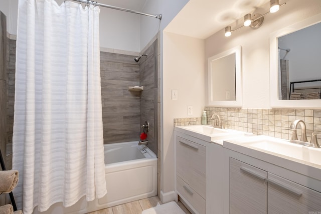 bathroom featuring shower / bath combination with curtain, tasteful backsplash, dual sinks, and vanity with extensive cabinet space