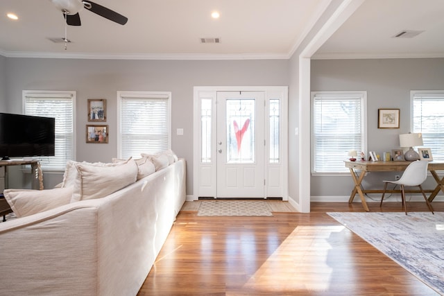 entryway with ceiling fan, ornamental molding, and light hardwood / wood-style floors