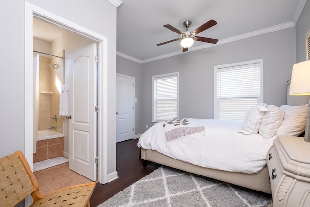 bedroom featuring crown molding, ensuite bath, wood-type flooring, and ceiling fan