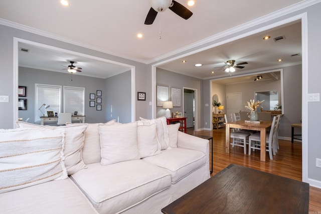 living room with crown molding, dark hardwood / wood-style floors, and ceiling fan