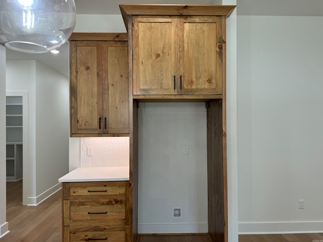 kitchen with backsplash and wood-type flooring