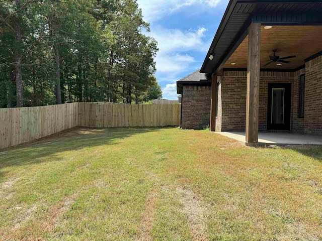 view of yard featuring ceiling fan and a patio area