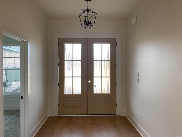 doorway with a wealth of natural light, hardwood / wood-style flooring, and french doors