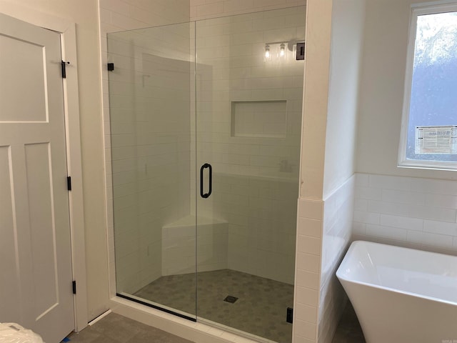 bathroom with separate shower and tub and tile patterned floors