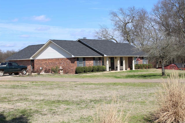 single story home with covered porch and a front lawn