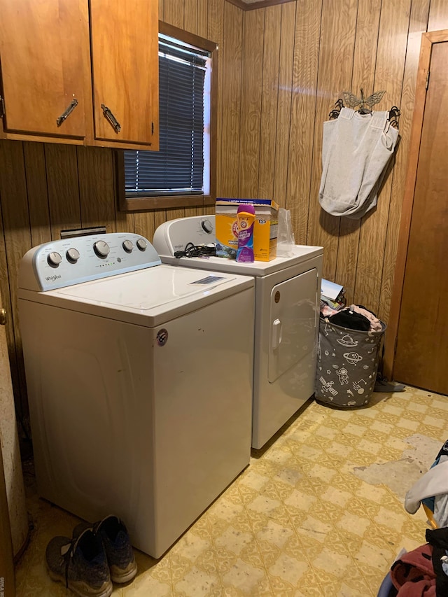 interior space featuring washer and clothes dryer and wooden walls