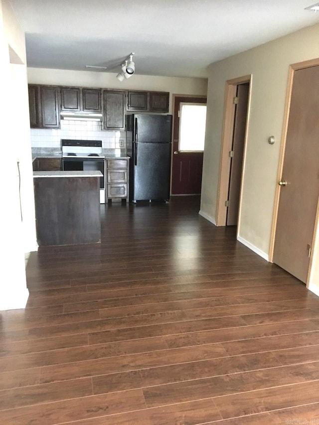 kitchen with range with electric stovetop, black fridge, dark brown cabinets, dark hardwood / wood-style floors, and backsplash