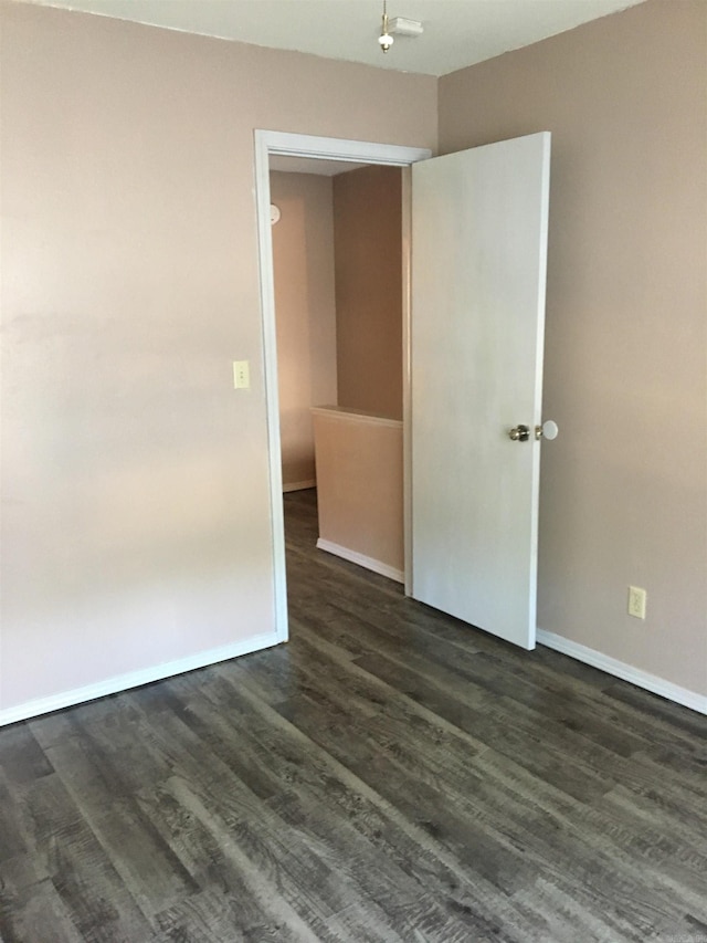 spare room with dark hardwood / wood-style floors