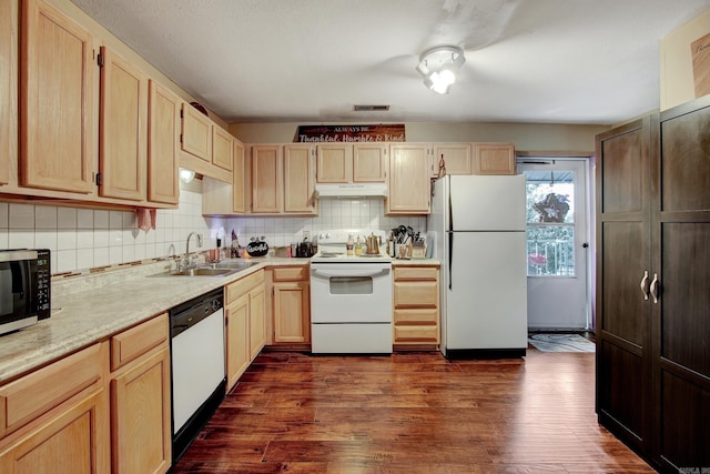 kitchen featuring dark wood-type flooring, white appliances, sink, light brown cabinetry, and tasteful backsplash