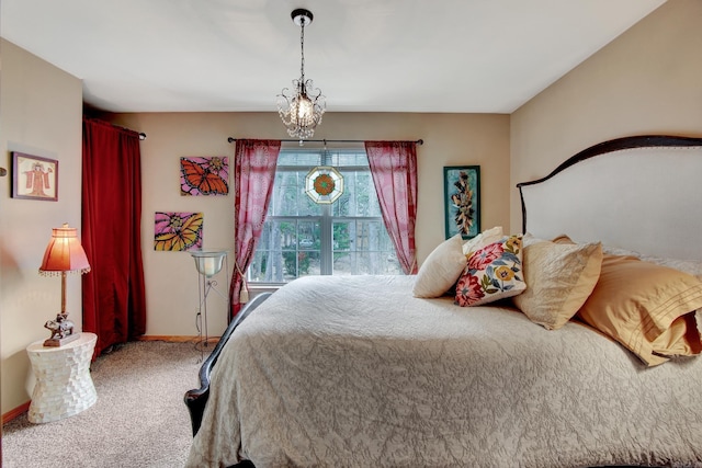 bedroom featuring an inviting chandelier and carpet floors