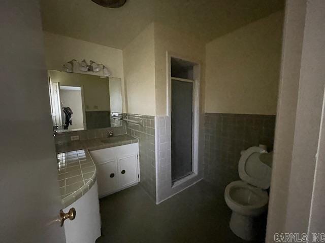 bathroom featuring vanity, tasteful backsplash, toilet, and tile walls