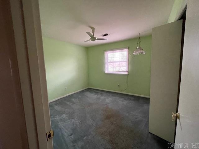 carpeted spare room with ceiling fan