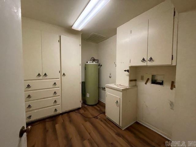 laundry room featuring dark hardwood / wood-style flooring, hookup for a washing machine, and water heater