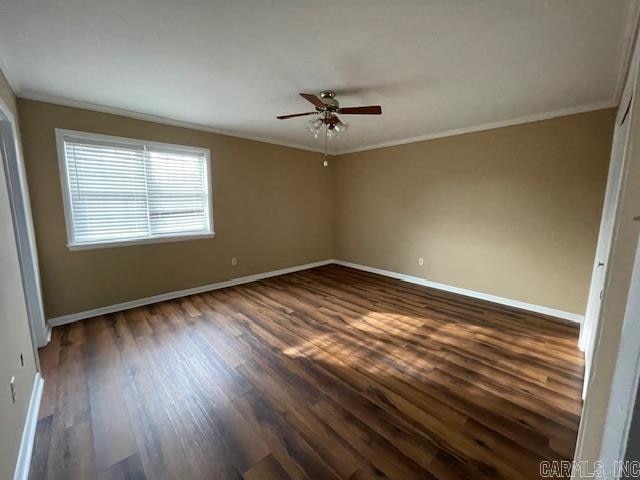 empty room with ceiling fan, ornamental molding, and dark wood-type flooring