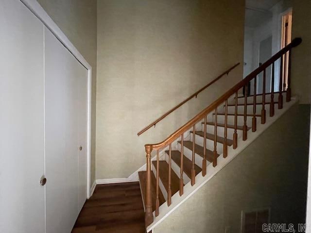 stairs featuring dark hardwood / wood-style floors