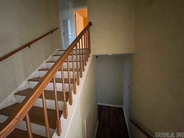 stairs featuring hardwood / wood-style floors