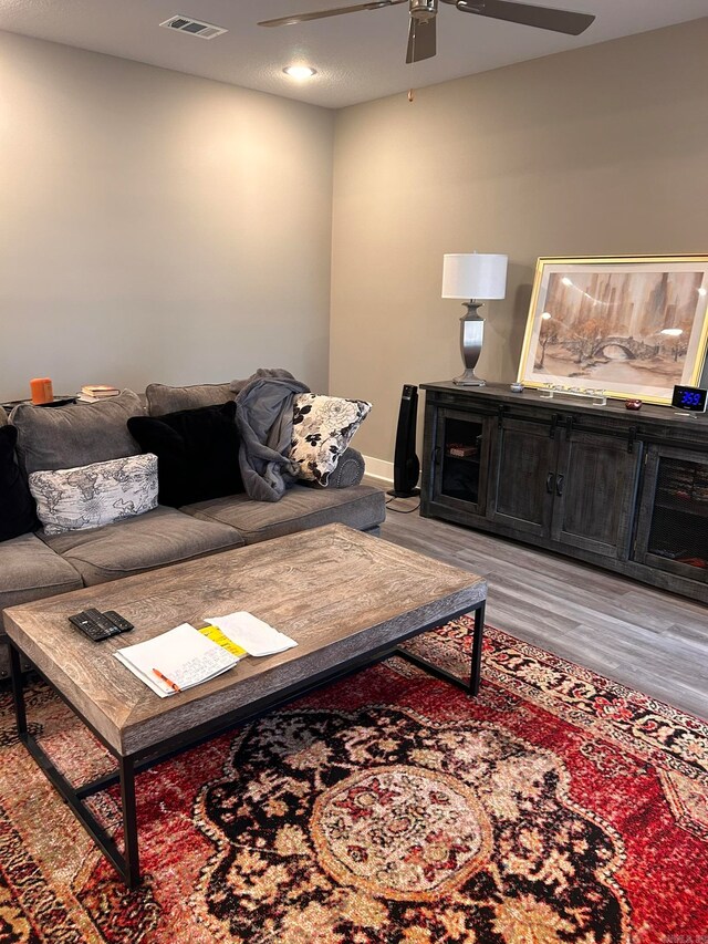 living room featuring ceiling fan and light wood-type flooring