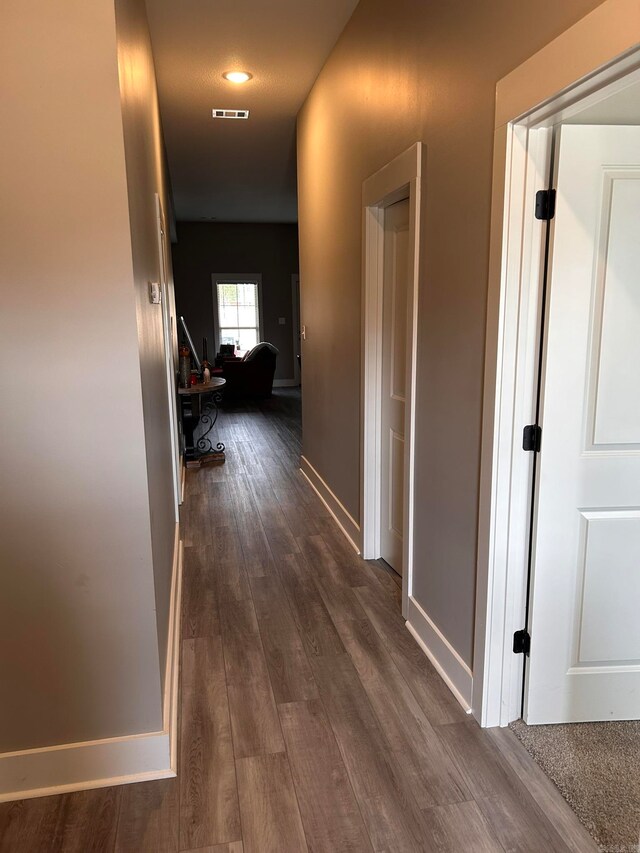 corridor with dark wood-type flooring