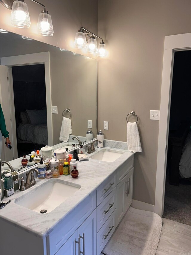 bathroom with double sink, oversized vanity, and tile flooring