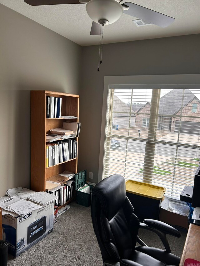 home office featuring ceiling fan and dark carpet