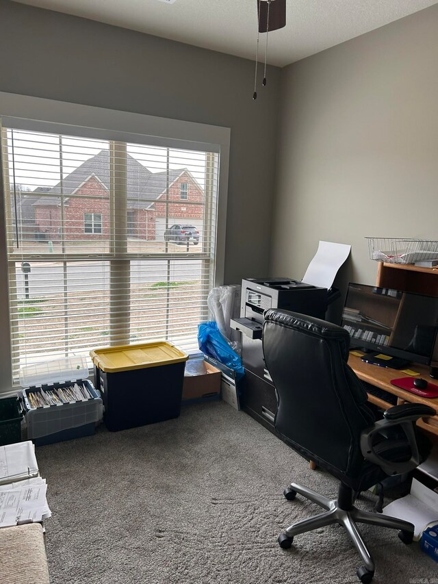 carpeted home office featuring ceiling fan and a textured ceiling