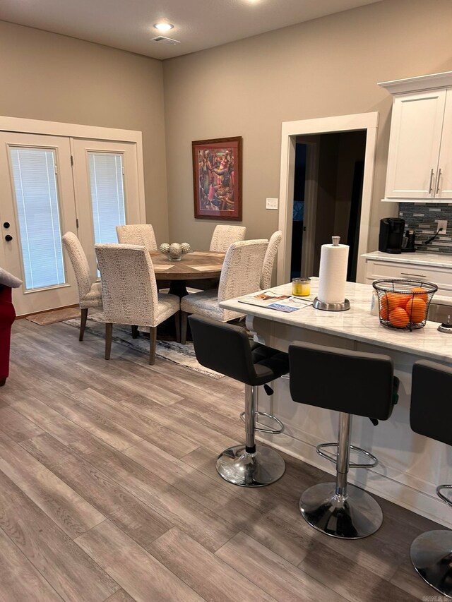 dining area featuring french doors and light hardwood / wood-style flooring