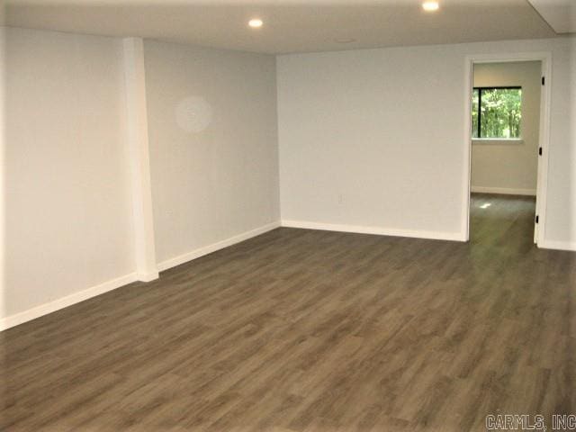 spare room with dark hardwood / wood-style flooring