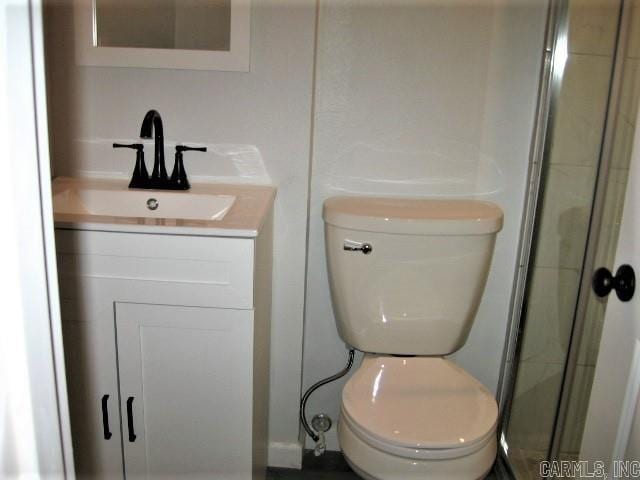 bathroom featuring toilet and vanity