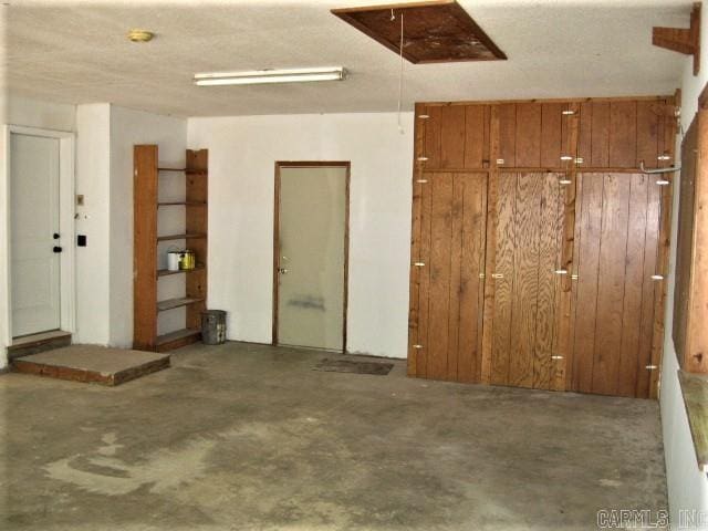 garage featuring wooden walls