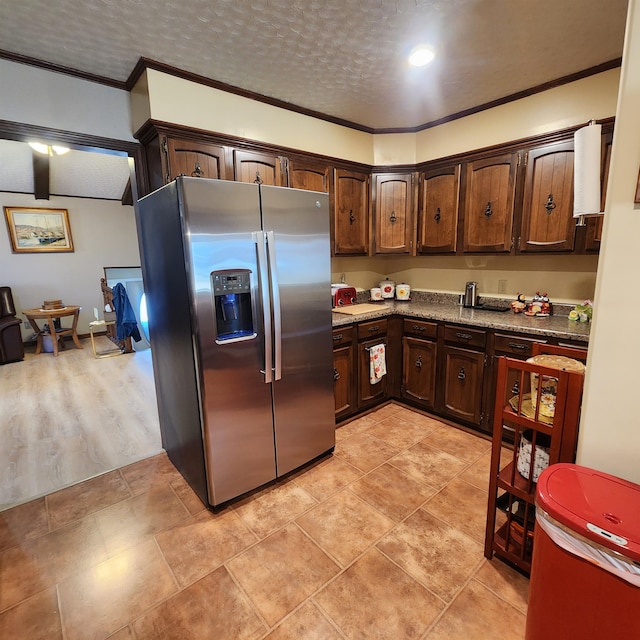 kitchen featuring dark brown cabinets, stainless steel fridge with ice dispenser, light hardwood / wood-style flooring, and crown molding